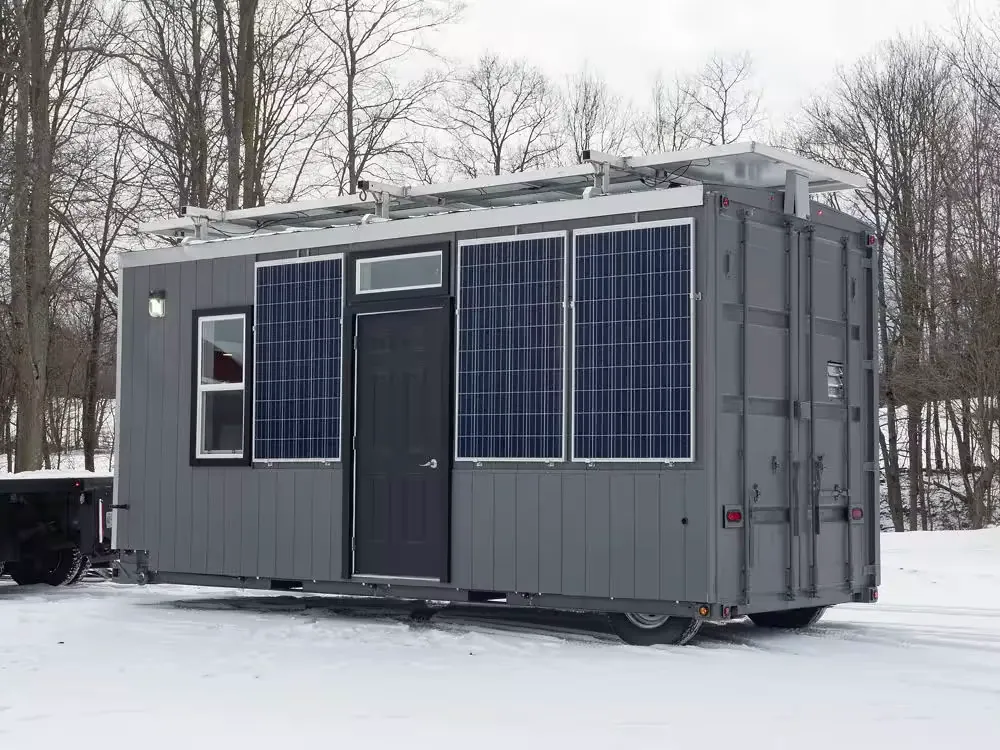 Insula container trailer with solar panels and windows parked in the snow